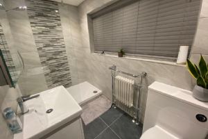 View En suite area with walk in shower which involved using some space form the main hallway.